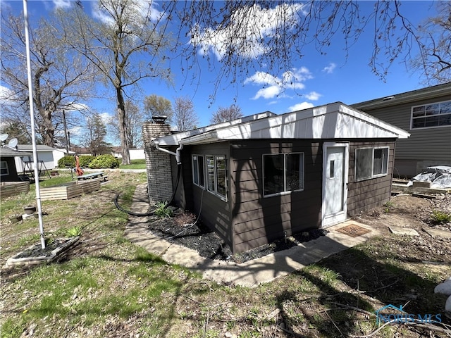 rear view of property with a chimney