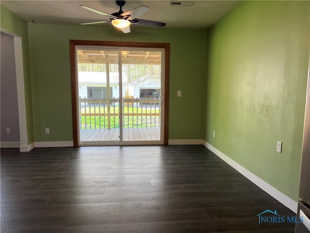 unfurnished room with baseboards, a ceiling fan, dark wood-style flooring, and visible vents