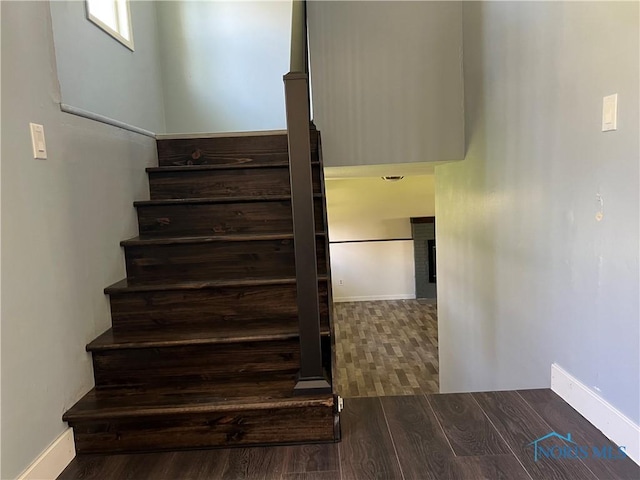 stairs featuring baseboards and wood finished floors