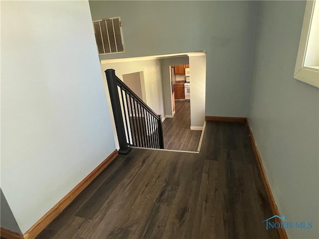 interior space featuring baseboards, visible vents, and dark wood-type flooring