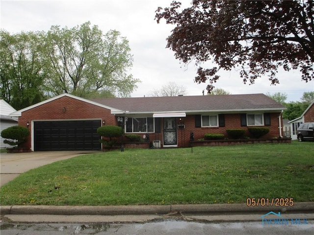single story home featuring an attached garage, a front yard, and brick siding