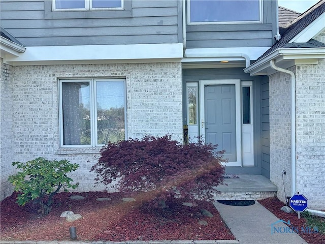 property entrance with brick siding