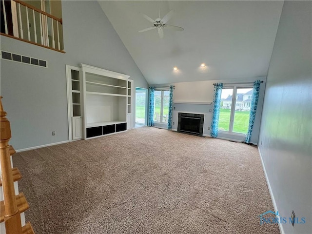 unfurnished living room with high vaulted ceiling, ceiling fan, carpet floors, and visible vents