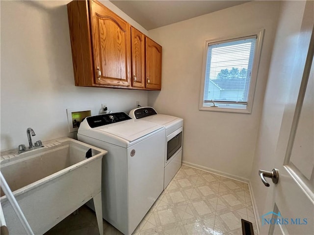 clothes washing area with cabinet space, a sink, separate washer and dryer, baseboards, and visible vents