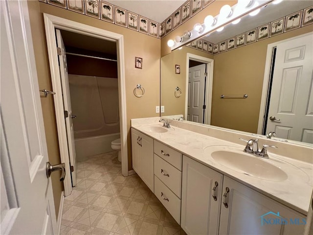 full bath featuring a sink, toilet, double vanity, and shower / tub combination