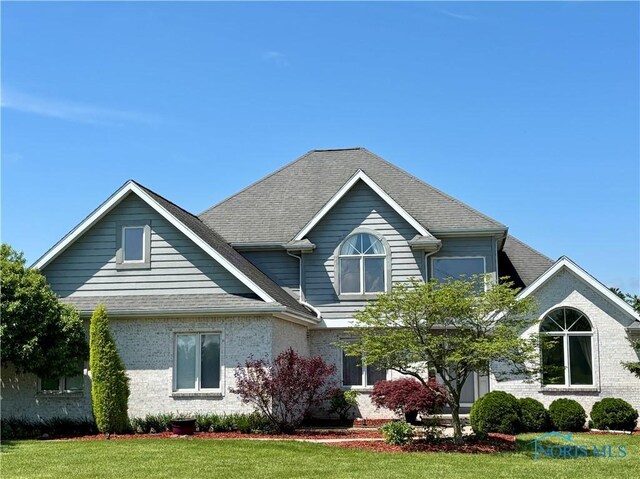 3518 Butz Rd, Maumee, OH 43537 - view of front facade with a shingled roof and a front lawn