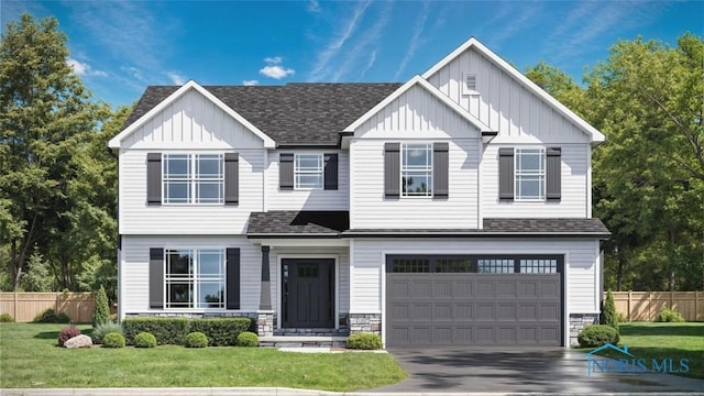 view of front of property featuring board and batten siding, fence, and a shingled roof