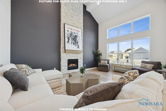 living room featuring high vaulted ceiling, a stone fireplace, and wood finished floors