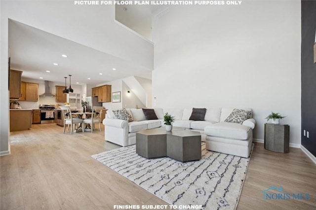living area featuring recessed lighting, baseboards, and light wood-type flooring