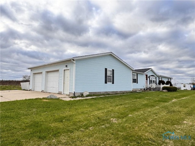view of home's exterior featuring a garage and a yard