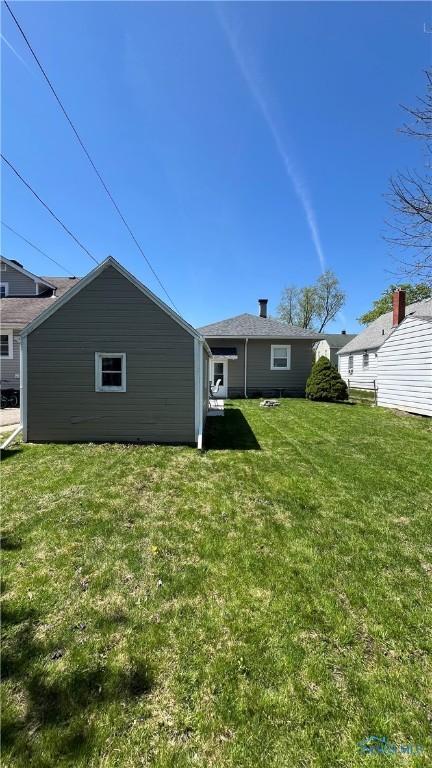 back of house with a yard