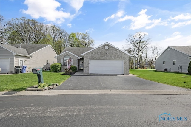 ranch-style house with brick siding, a garage, a front lawn, and aphalt driveway