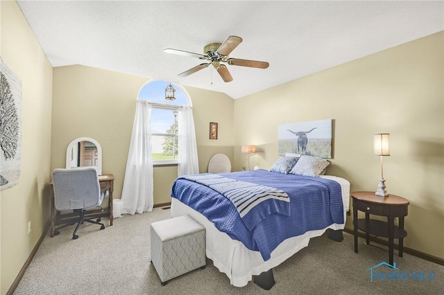 carpeted bedroom featuring baseboards and a ceiling fan