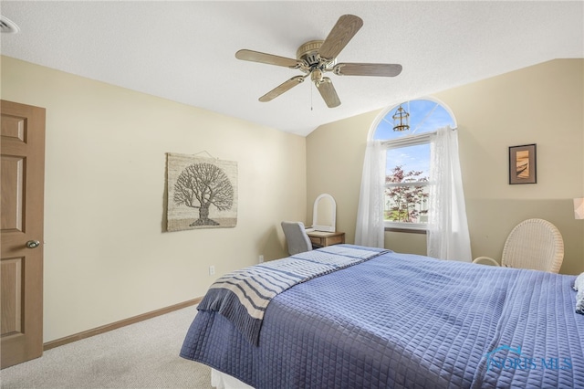 carpeted bedroom featuring baseboards, ceiling fan, and vaulted ceiling