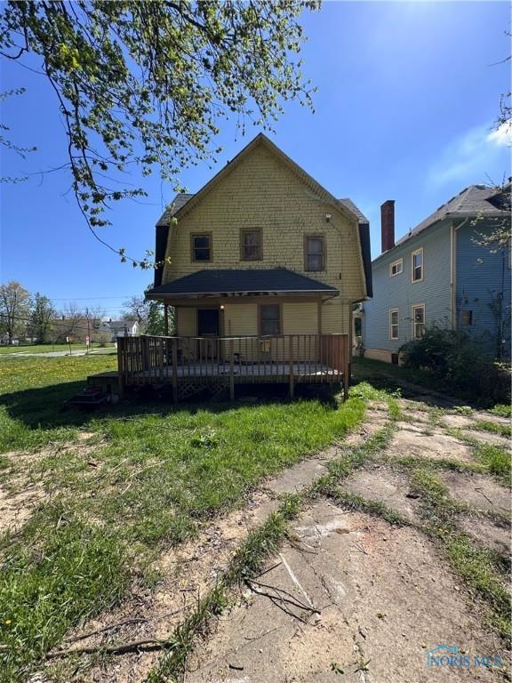 2435 Warren St, Toledo, OH 43620 - rear view of property featuring a gambrel roof, a yard, and a deck