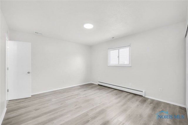 6040 Rolland Dr, Toledo, OH 43612 - empty room with baseboard heating, wood finished floors, and baseboards