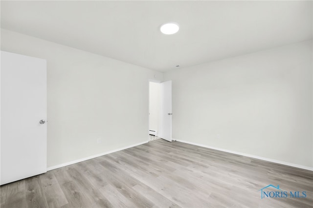 6040 Rolland Dr, Toledo, OH 43612 - unfurnished room with wood finished floors, baseboard heating, and baseboards