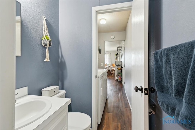 2123 Keen Ave, Toledo, OH 43611 - bathroom with vanity, toilet, wood finished floors, and washing machine and clothes dryer