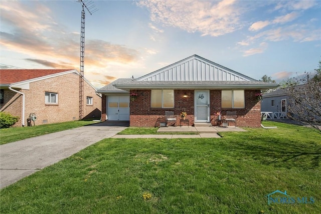 2123 Keen Ave, Toledo, OH 43611 - bungalow-style home with a yard, board and batten siding, concrete driveway, and brick siding