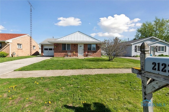 2123 Keen Ave, Toledo, OH 43611 - bungalow with a front lawn, brick siding, a garage, board and batten siding, and concrete driveway