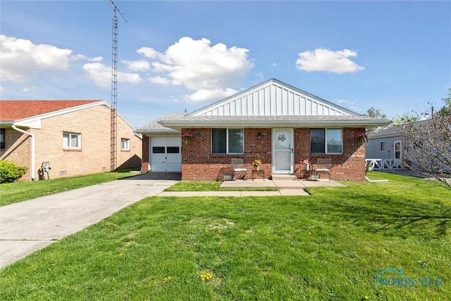 2123 Keen Ave, Toledo, OH 43611 - bungalow-style home featuring board and batten siding, brick siding, driveway, and a front yard