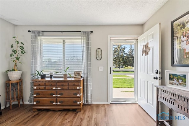 2123 Keen Ave, Toledo, OH 43611 - entryway with a textured ceiling, baseboards, and wood finished floors