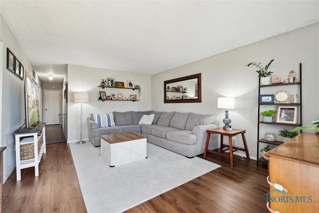 2123 Keen Ave, Toledo, OH 43611 - living area with baseboards, a textured ceiling, and dark wood-style flooring