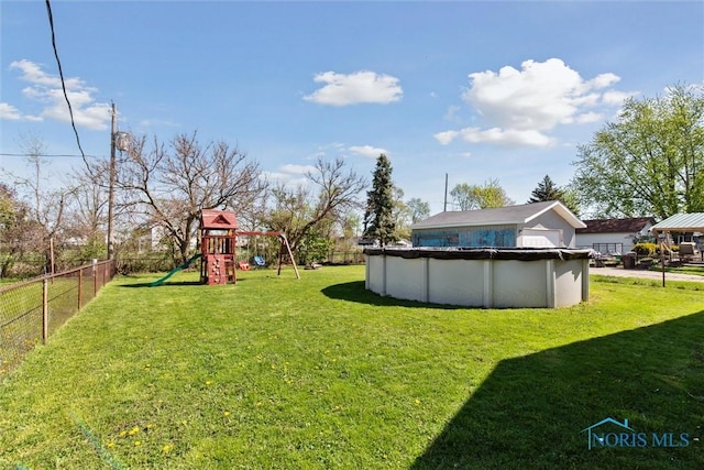 2123 Keen Ave, Toledo, OH 43611 - view of yard featuring a fenced backyard, a playground, and a covered pool