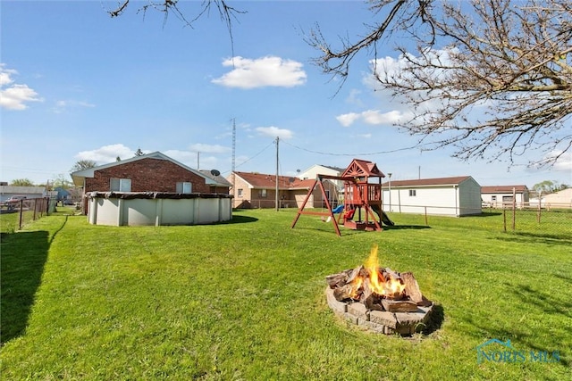 2123 Keen Ave, Toledo, OH 43611 - view of yard with a fenced backyard, a playground, a fire pit, and a covered pool