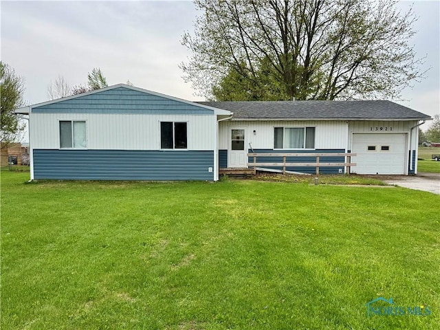 ranch-style home with driveway, a shingled roof, a front lawn, and a garage