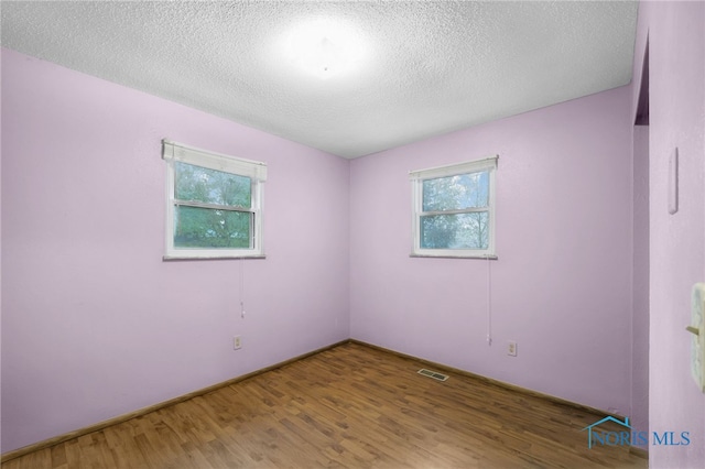 13921 Defiance Pike, Rudolph, OH 43462 - empty room featuring wood finished floors and a textured ceiling