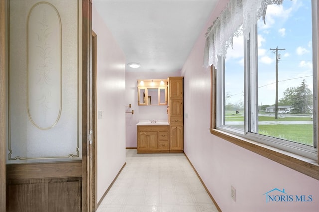 13921 Defiance Pike, Rudolph, OH 43462 - hallway featuring light flooring, baseboards, and a sink