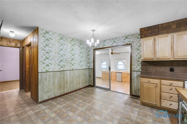 13921 Defiance Pike, Rudolph, OH 43462 - unfurnished dining area featuring a textured ceiling, a chandelier, wooden walls, a ceiling fan, and a wainscoted wall