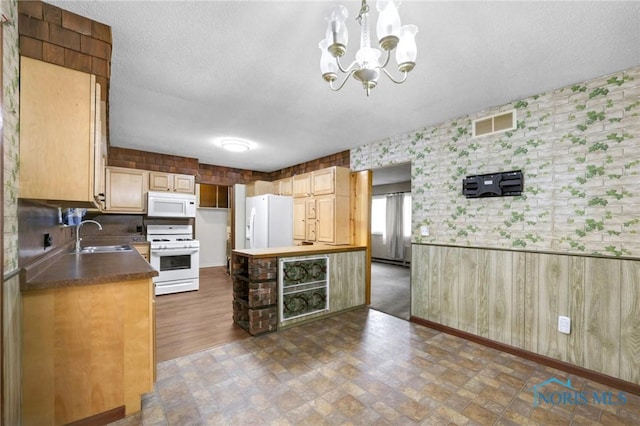 13921 Defiance Pike, Rudolph, OH 43462 - kitchen with white appliances, a chandelier, a sink, baseboards, and a kitchen island