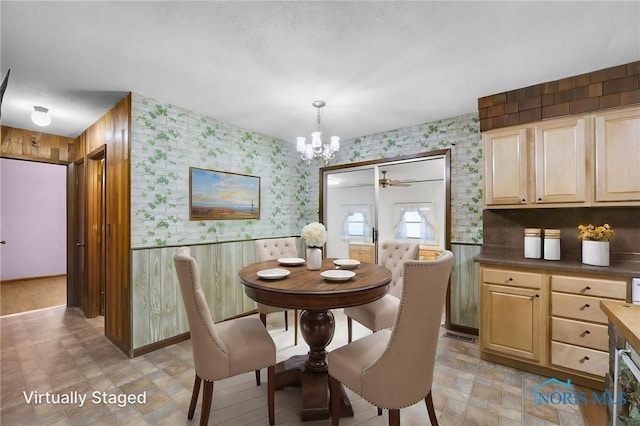 13921 Defiance Pike, Rudolph, OH 43462 - dining space featuring wallpapered walls, a chandelier, and ceiling fan