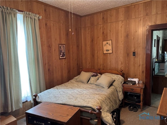 bedroom with wooden walls and carpet floors