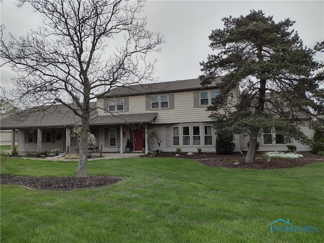 traditional-style home with a porch and a front lawn