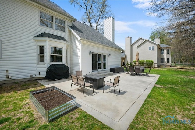 1135 Pimlico Park, Holland, OH 43528 - rear view of house with a garden, a patio, roof with shingles, a chimney, and a yard