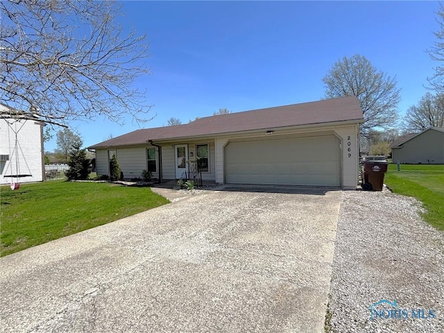 ranch-style house featuring an attached garage, concrete driveway, and a front yard