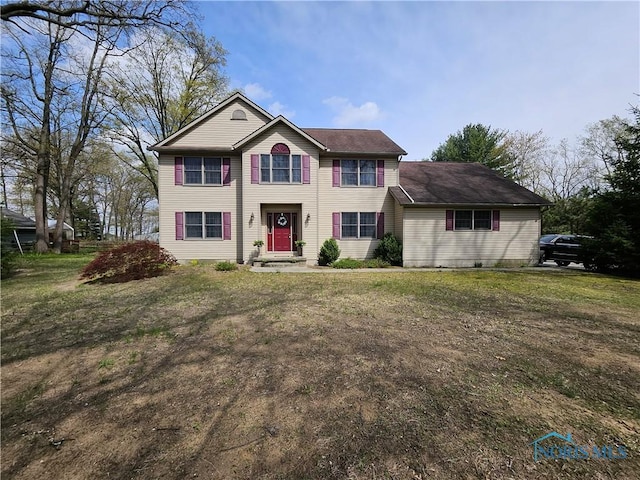 colonial-style house with a front lawn