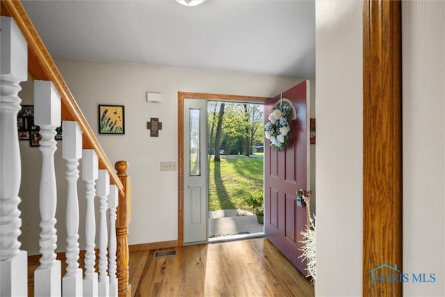 2515 S Berkey Southern Rd, Swanton, OH 43558 - entryway with light wood-style flooring, baseboards, and stairway