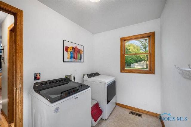 2515 S Berkey Southern Rd, Swanton, OH 43558 - clothes washing area featuring washer and clothes dryer, baseboards, and light flooring