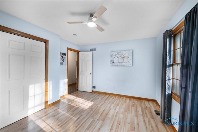 2515 S Berkey Southern Rd, Swanton, OH 43558 - unfurnished bedroom with baseboards, light wood finished floors, and ceiling fan
