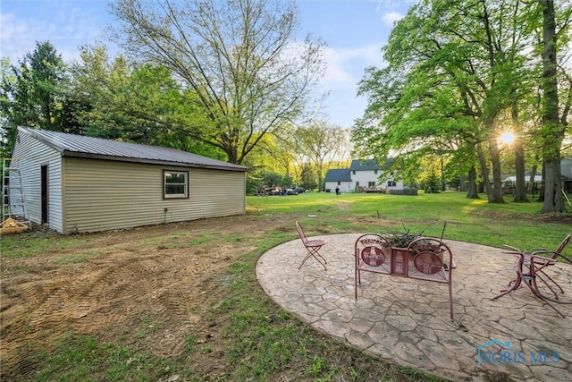 2515 S Berkey Southern Rd, Swanton, OH 43558 - view of grassy yard featuring a patio, a fire pit, and an outdoor structure