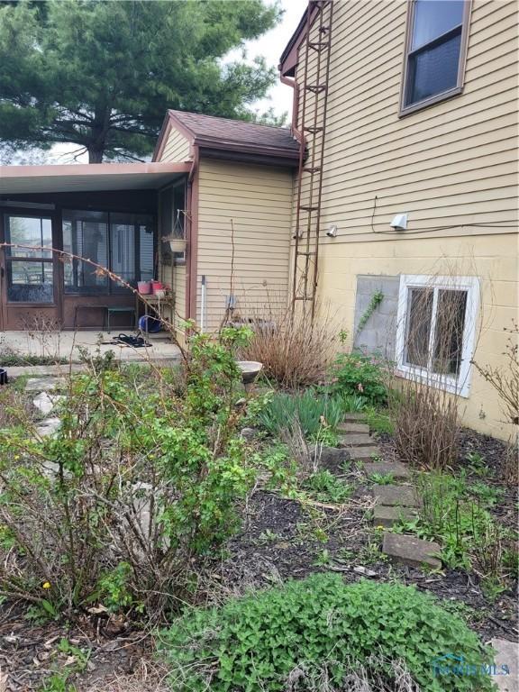 view of side of home featuring a sunroom