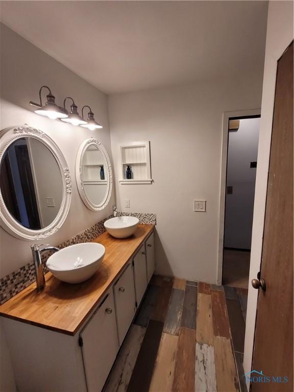 633 Southfield Dr, Maumee, OH 43537 - bathroom featuring double vanity and wood finished floors