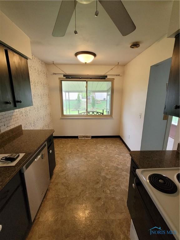 633 Southfield Dr, Maumee, OH 43537 - kitchen featuring ceiling fan, healthy amount of natural light, dark countertops, and stainless steel dishwasher
