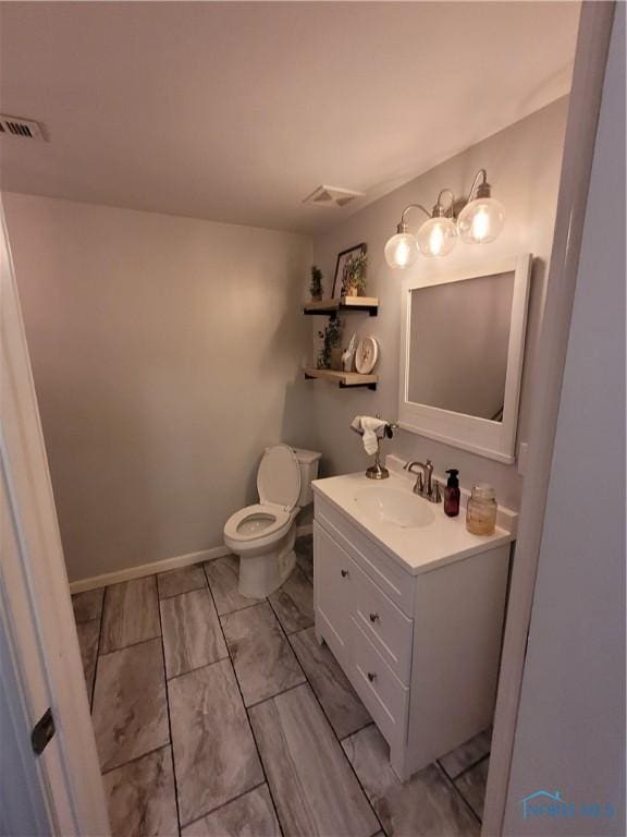 633 Southfield Dr, Maumee, OH 43537 - bathroom with toilet, vanity, and baseboards