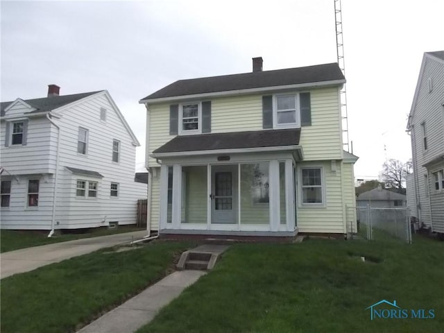 view of front facade with a chimney and a front yard