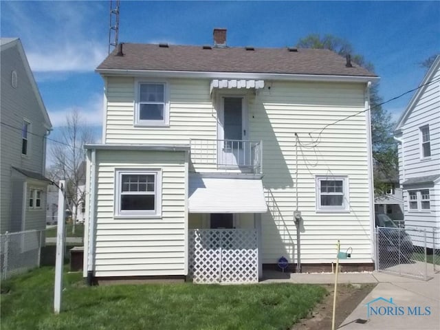 back of house with fence and a balcony
